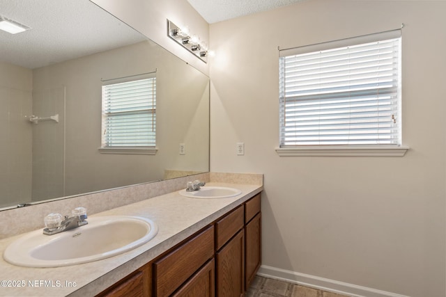 bathroom with vanity and a textured ceiling