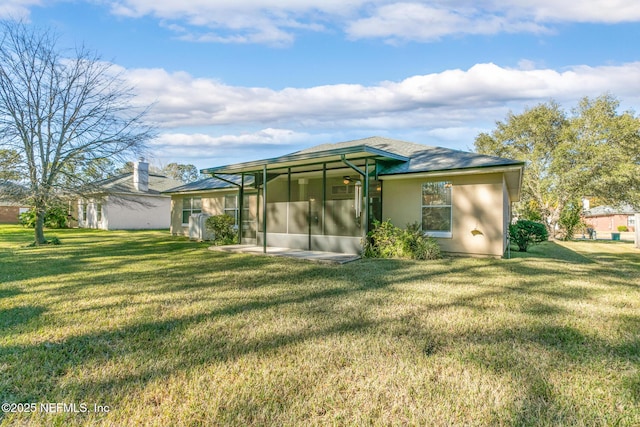 back of property featuring a yard