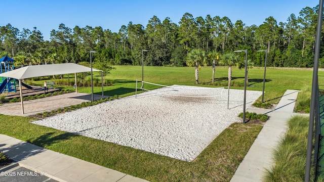 surrounding community featuring volleyball court, a yard, and a playground