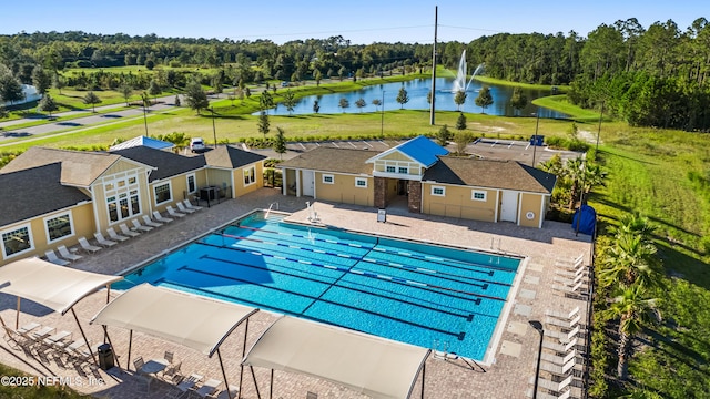 view of pool with a patio area and a water view