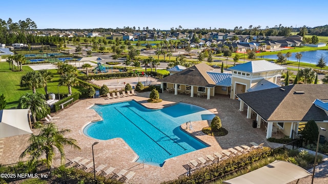 view of pool with a water view and a patio