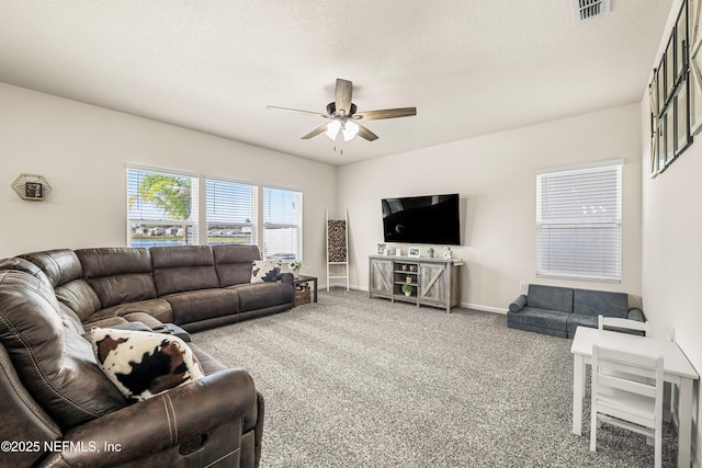 living room featuring ceiling fan, a textured ceiling, and carpet flooring