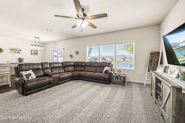 living room with ceiling fan, a textured ceiling, and carpet flooring