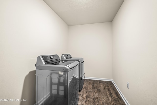 laundry area featuring a textured ceiling, dark hardwood / wood-style floors, and independent washer and dryer