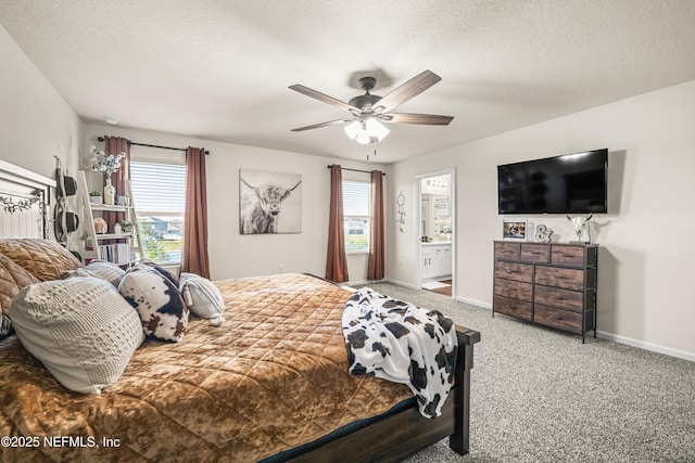 carpeted bedroom featuring a textured ceiling, ceiling fan, multiple windows, and ensuite bath