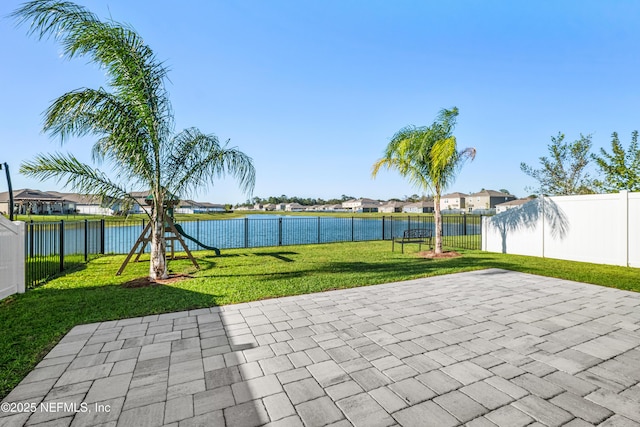 view of patio with a water view and a playground