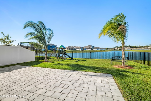 view of patio / terrace with a water view and a playground