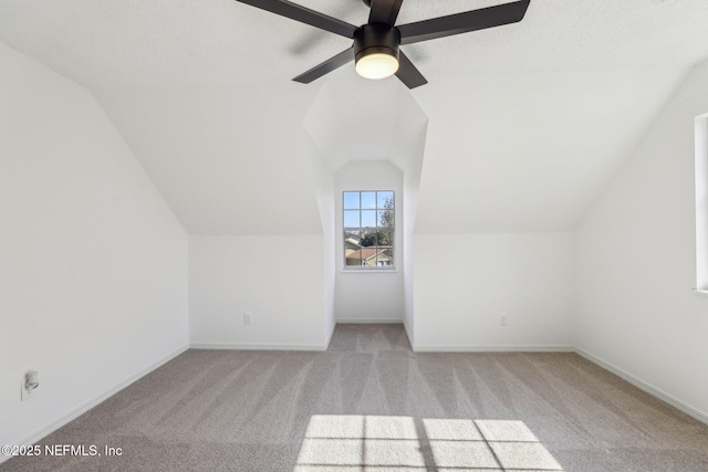 bonus room with ceiling fan, light colored carpet, and vaulted ceiling