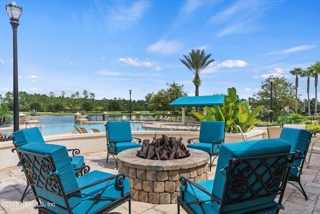 view of patio featuring a water view and a fire pit