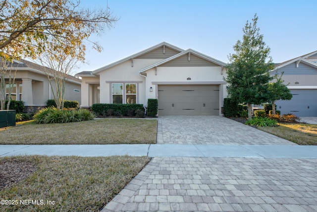 ranch-style home with a garage and a front yard