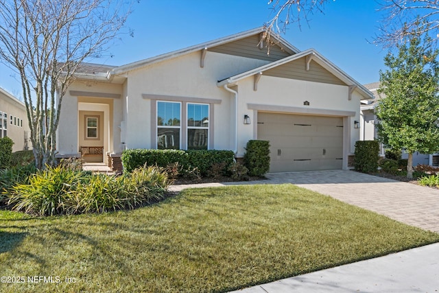 view of front of home featuring a garage and a front lawn