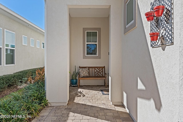 view of exterior entry featuring a patio area