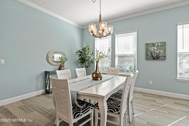 dining space featuring ornamental molding and an inviting chandelier