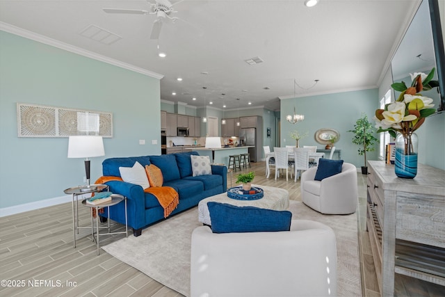 living room featuring ornamental molding and ceiling fan with notable chandelier