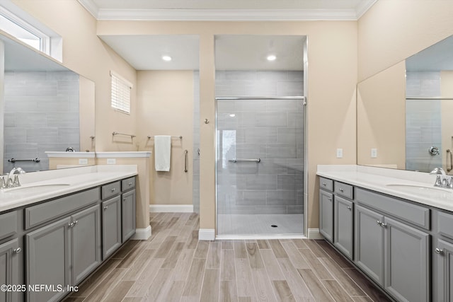 bathroom with crown molding, an enclosed shower, and vanity