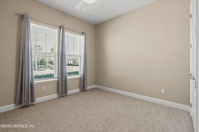 carpeted spare room with ceiling fan