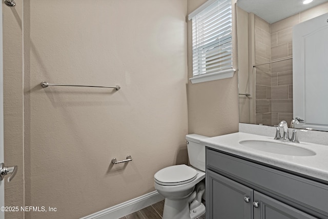 bathroom featuring toilet, hardwood / wood-style flooring, and vanity