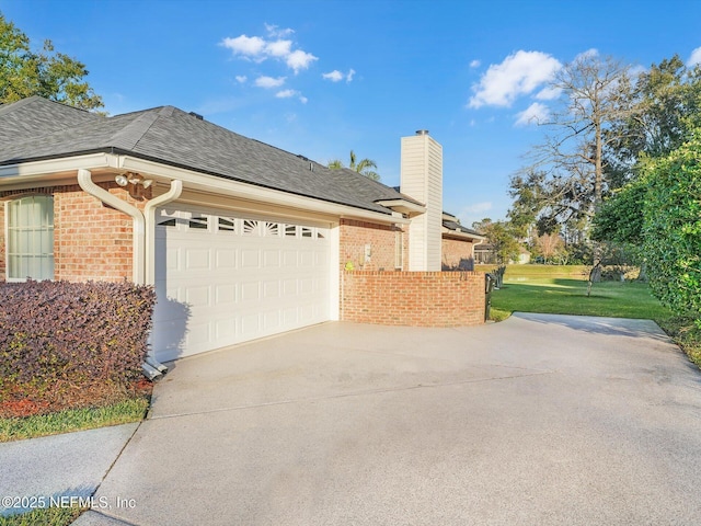 view of side of home featuring a garage and a yard