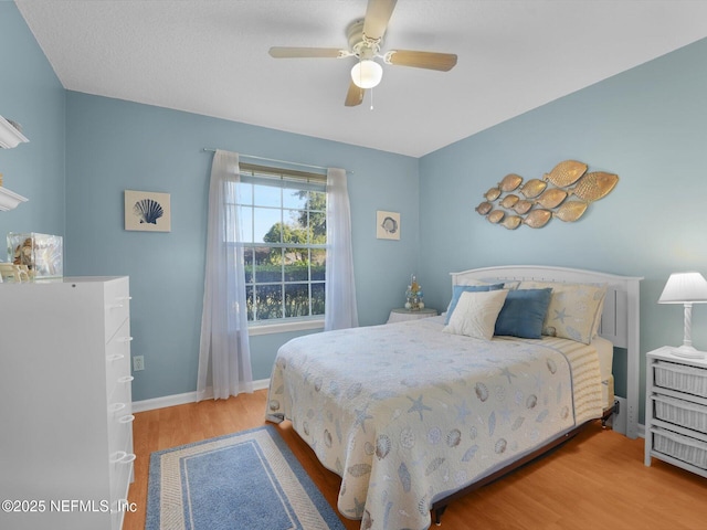 bedroom with ceiling fan and wood-type flooring