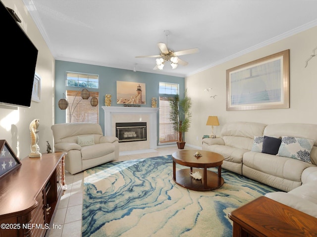 living room featuring ceiling fan, light tile patterned floors, and crown molding