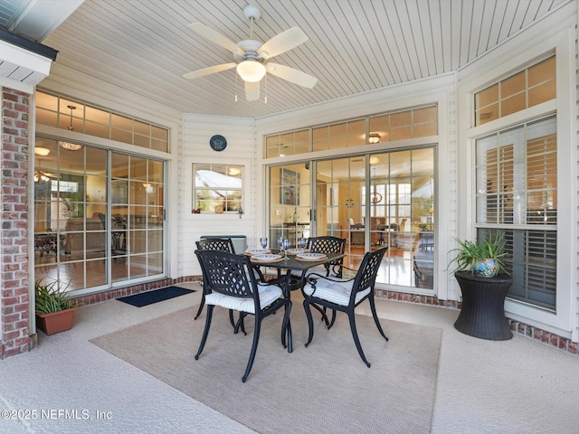 sunroom / solarium featuring ceiling fan, wood ceiling, and a healthy amount of sunlight