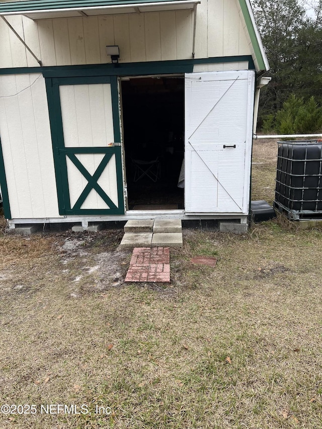 view of outdoor structure featuring central AC and a yard