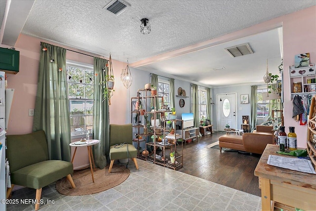 living area featuring crown molding, a textured ceiling, and dark hardwood / wood-style flooring