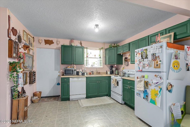 kitchen with sink, a textured ceiling, white appliances, and green cabinetry