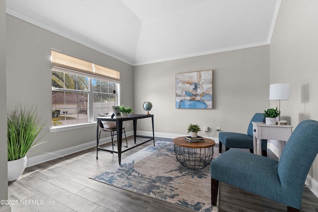 home office featuring vaulted ceiling, crown molding, and light wood-type flooring