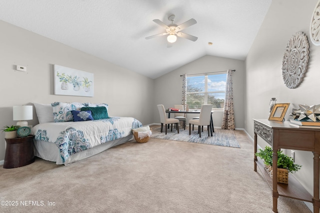 carpeted bedroom with lofted ceiling, a textured ceiling, and ceiling fan