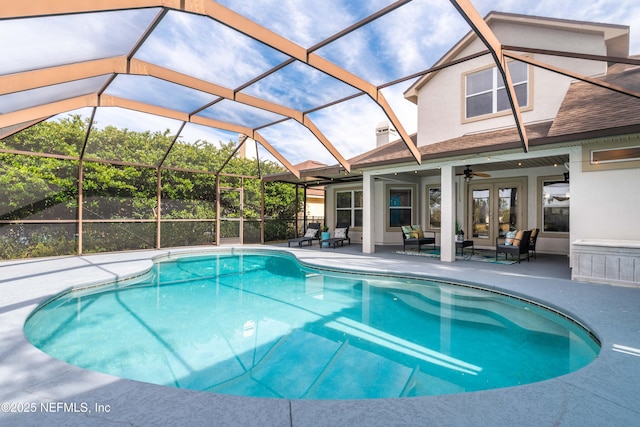 view of pool featuring french doors, an outdoor hangout area, ceiling fan, glass enclosure, and a patio area