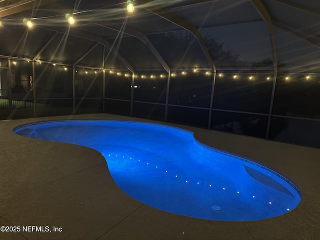 pool at night with glass enclosure