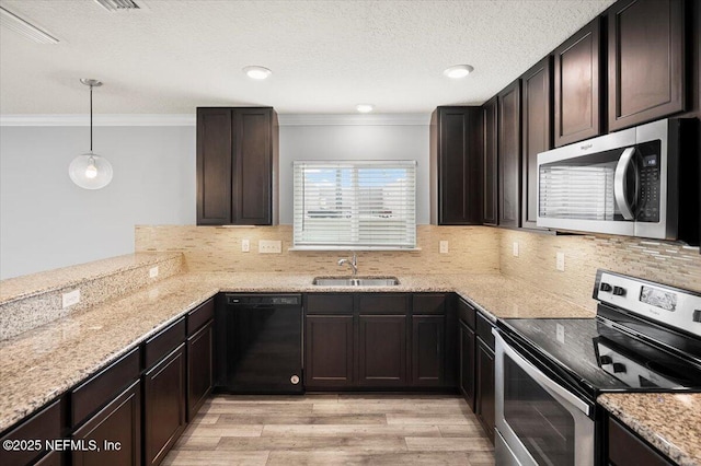 kitchen featuring appliances with stainless steel finishes, sink, ornamental molding, and pendant lighting