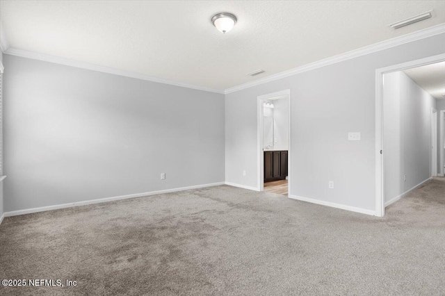 carpeted empty room with crown molding