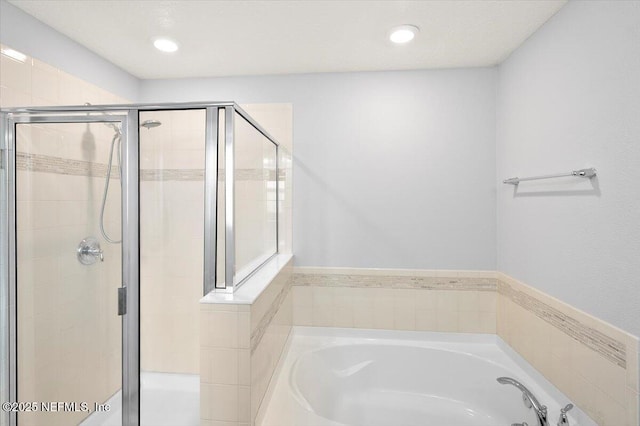 bathroom featuring separate shower and tub