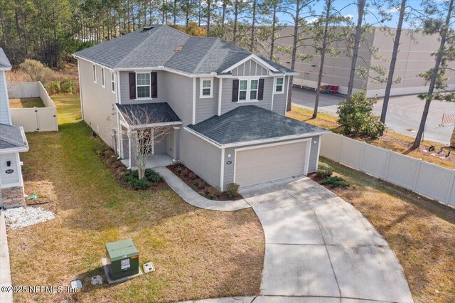 view of property featuring a front yard and a garage