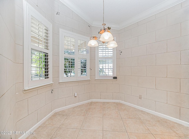 unfurnished dining area featuring tile patterned floors and ornamental molding