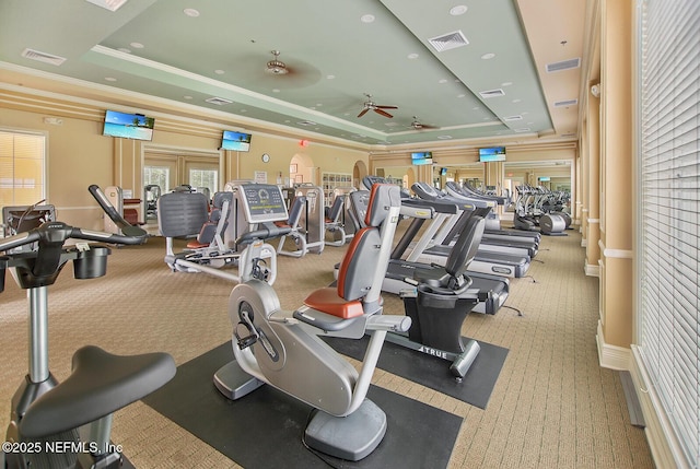 workout area with crown molding, visible vents, and a raised ceiling