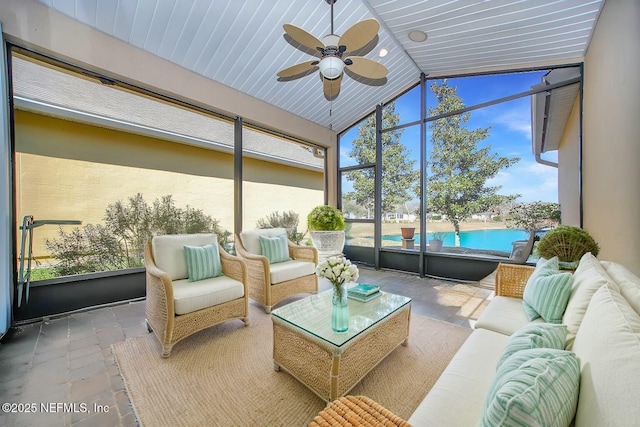 sunroom featuring lofted ceiling and ceiling fan