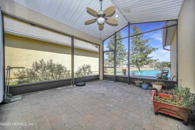 unfurnished sunroom featuring lofted ceiling and ceiling fan