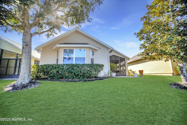 view of front of property featuring a front lawn and a sunroom