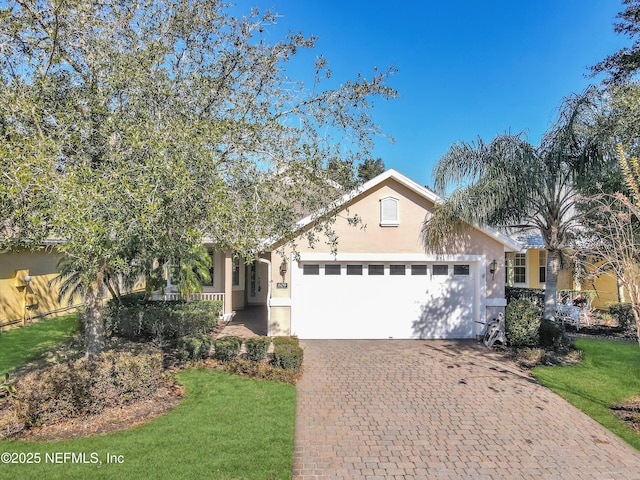 view of front of house with a garage and a front lawn