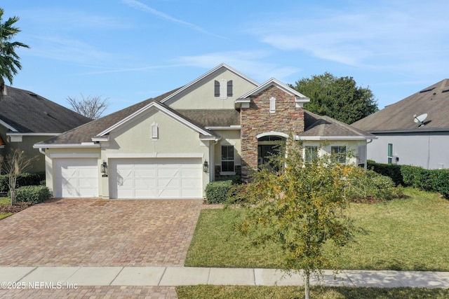 front of property with a garage and a front lawn