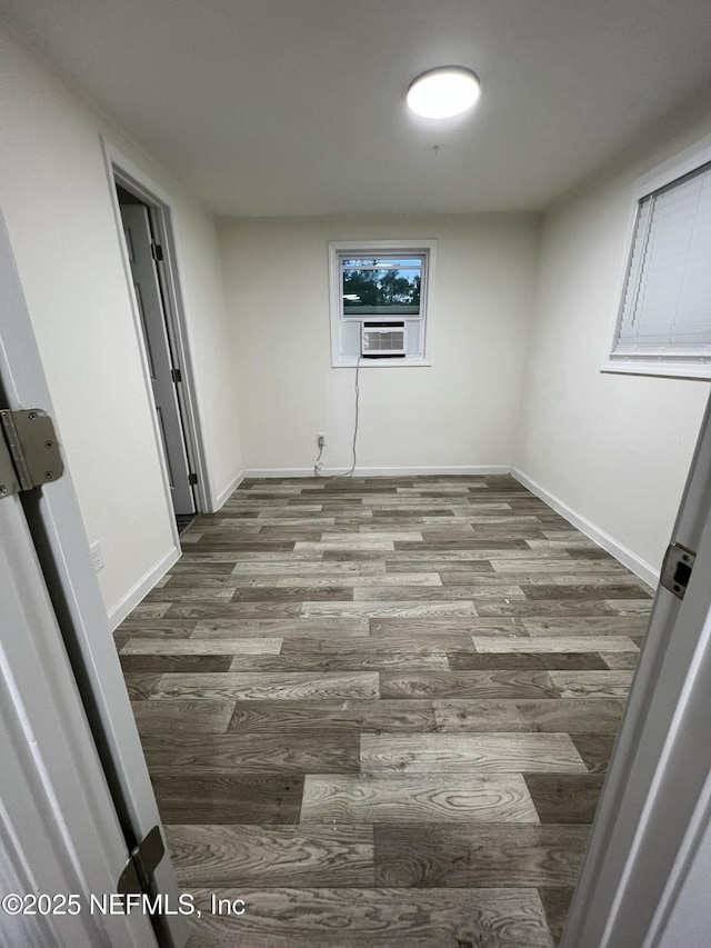 empty room with cooling unit and wood-type flooring