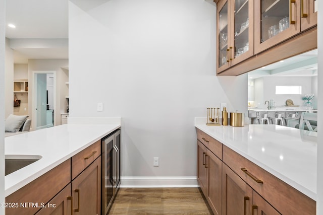 kitchen featuring sink, wine cooler, and dark hardwood / wood-style floors