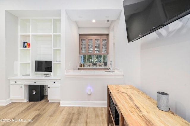 office space with sink and light hardwood / wood-style flooring