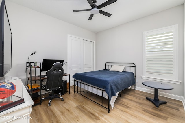 bedroom featuring light hardwood / wood-style floors, a closet, and ceiling fan