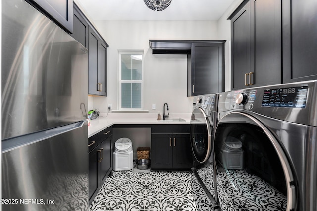 washroom with independent washer and dryer, cabinets, and sink