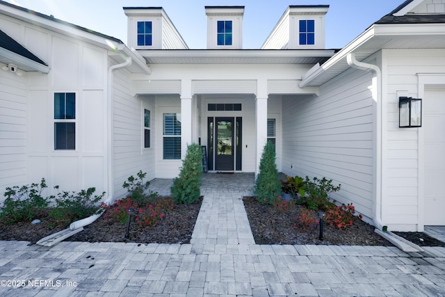 entrance to property featuring covered porch