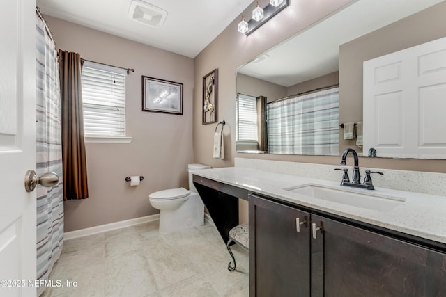 bathroom featuring vanity and toilet